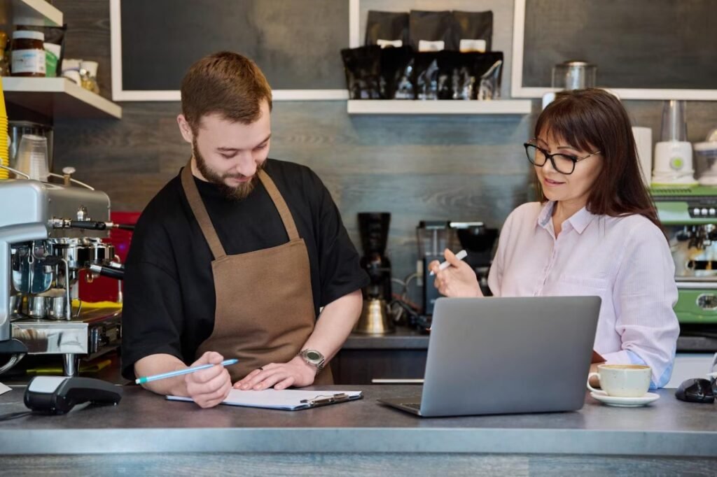 Café owner and accountant reviewing business records
