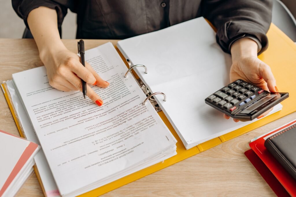 Person reviewing paperwork in a binder